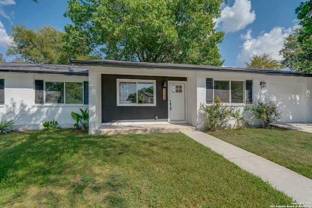 ranch-style home with a garage, a porch, and a front lawn