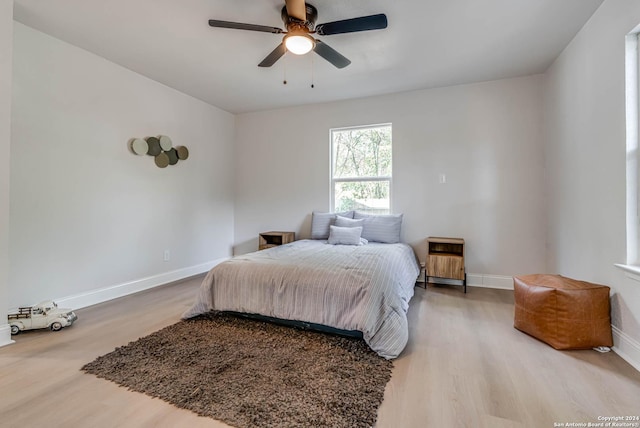 bedroom with hardwood / wood-style flooring and ceiling fan