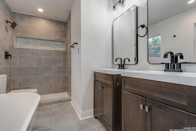 bathroom featuring tiled shower, vanity, toilet, and tile patterned floors