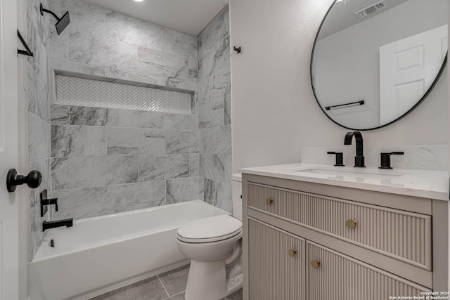 full bathroom featuring tiled shower / bath combo, vanity, tile patterned floors, and toilet