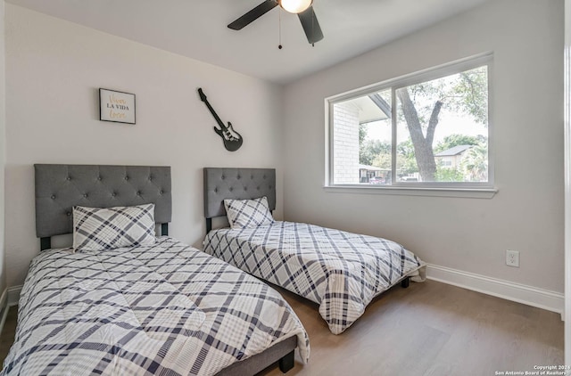 bedroom with wood-type flooring and ceiling fan