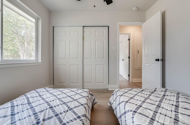 bedroom featuring hardwood / wood-style flooring, a closet, and ceiling fan