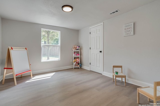 rec room with light hardwood / wood-style floors