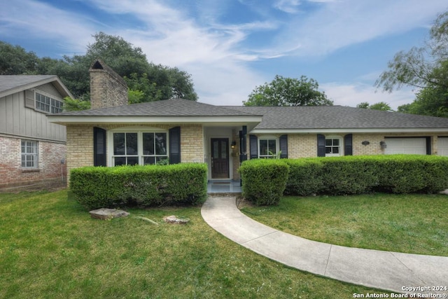 ranch-style home with a garage and a front yard