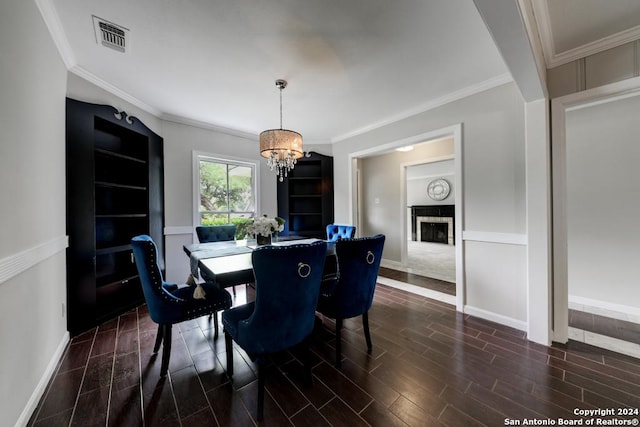 dining room featuring ornamental molding and a notable chandelier