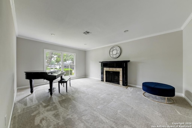 sitting room featuring a brick fireplace, ornamental molding, and carpet flooring