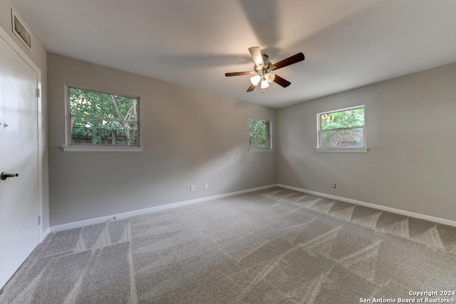 carpeted spare room with ceiling fan