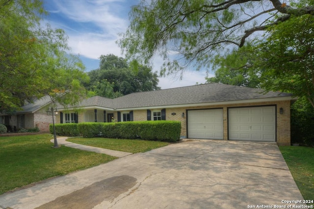 ranch-style house featuring a garage and a front lawn