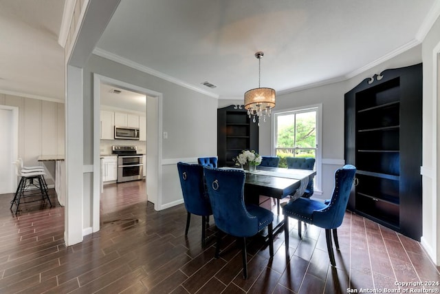 dining area with crown molding and a chandelier