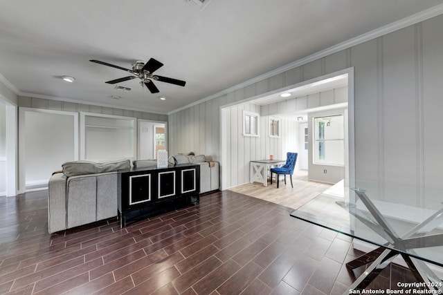 living room with ceiling fan, ornamental molding, and dark hardwood / wood-style flooring