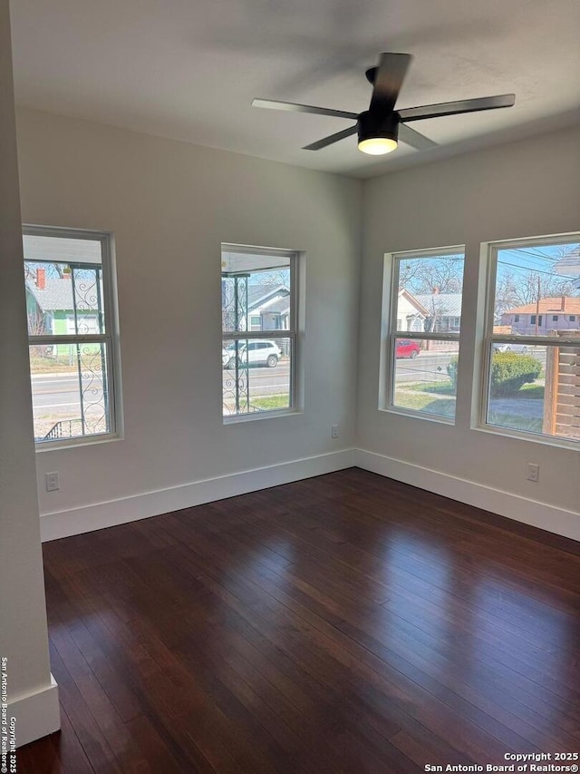 unfurnished room featuring dark hardwood / wood-style flooring and ceiling fan