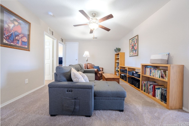 living room with ceiling fan and carpet