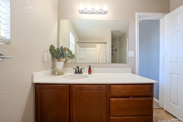 bathroom with vanity and walk in shower