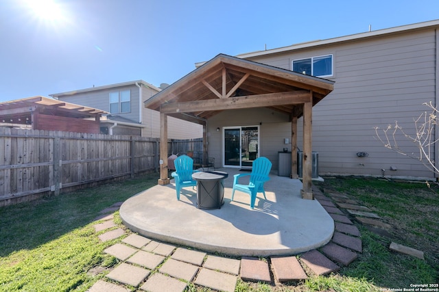 back of house featuring a fire pit, a yard, and a patio area