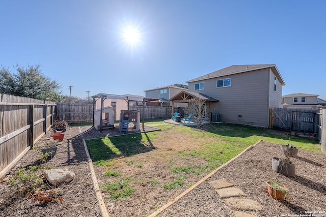 view of yard with central AC unit and a patio area