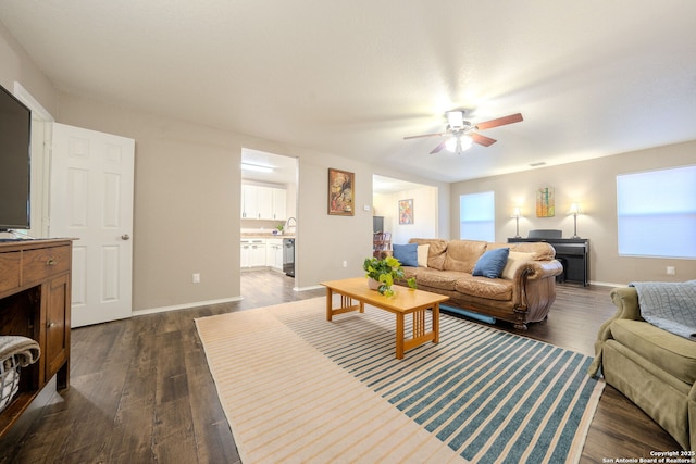 living room with ceiling fan, sink, and dark hardwood / wood-style flooring