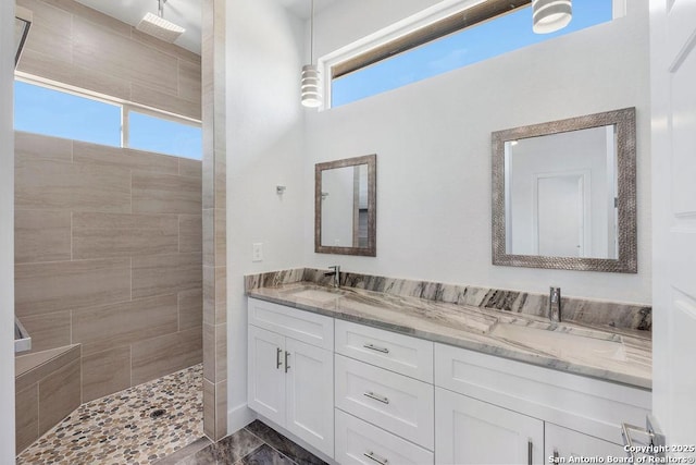 bathroom featuring vanity and tiled shower