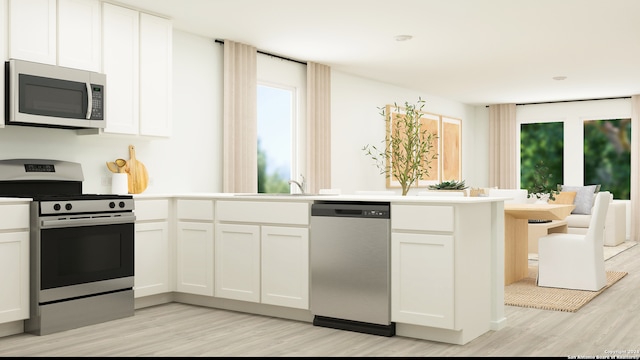 kitchen featuring sink, light hardwood / wood-style flooring, white cabinets, and appliances with stainless steel finishes