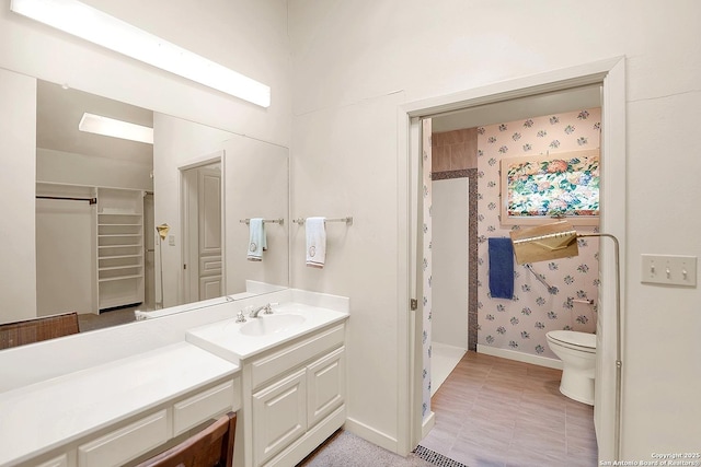 bathroom with vanity, toilet, and walk in shower