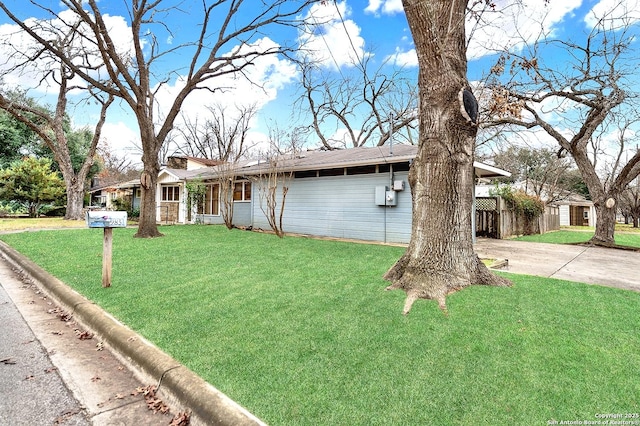 ranch-style home featuring a front lawn and a carport