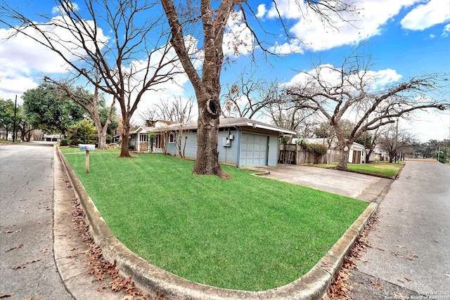 view of front of house with a garage and a front yard