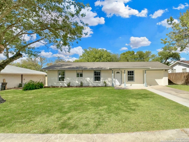 ranch-style house with cooling unit, a garage, and a front yard