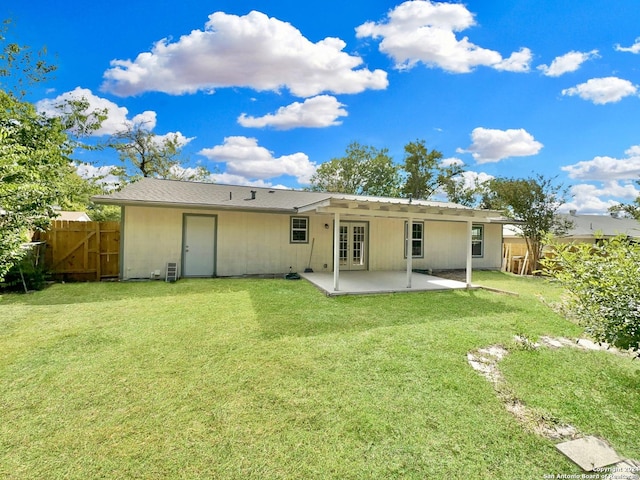 rear view of property featuring a lawn and a patio