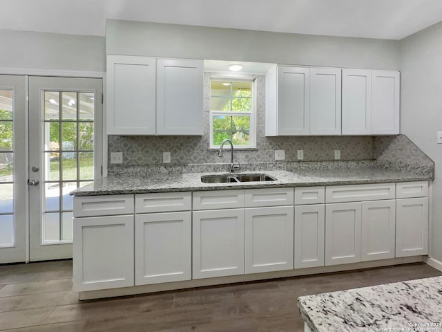 kitchen with sink, decorative backsplash, and white cabinets