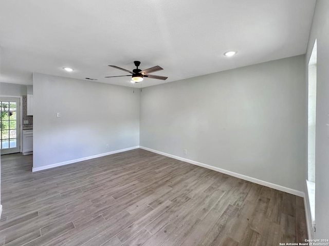 unfurnished room with ceiling fan and light wood-type flooring