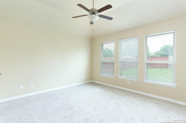 carpeted empty room featuring a healthy amount of sunlight and ceiling fan