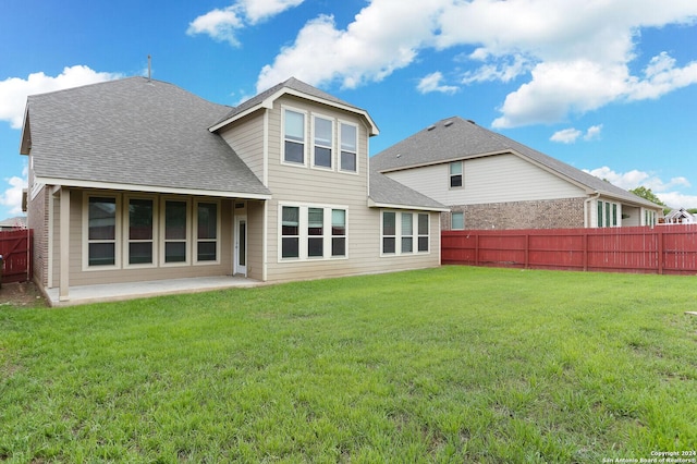 back of property featuring a yard and a patio area