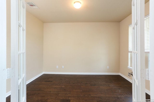 spare room with dark hardwood / wood-style flooring