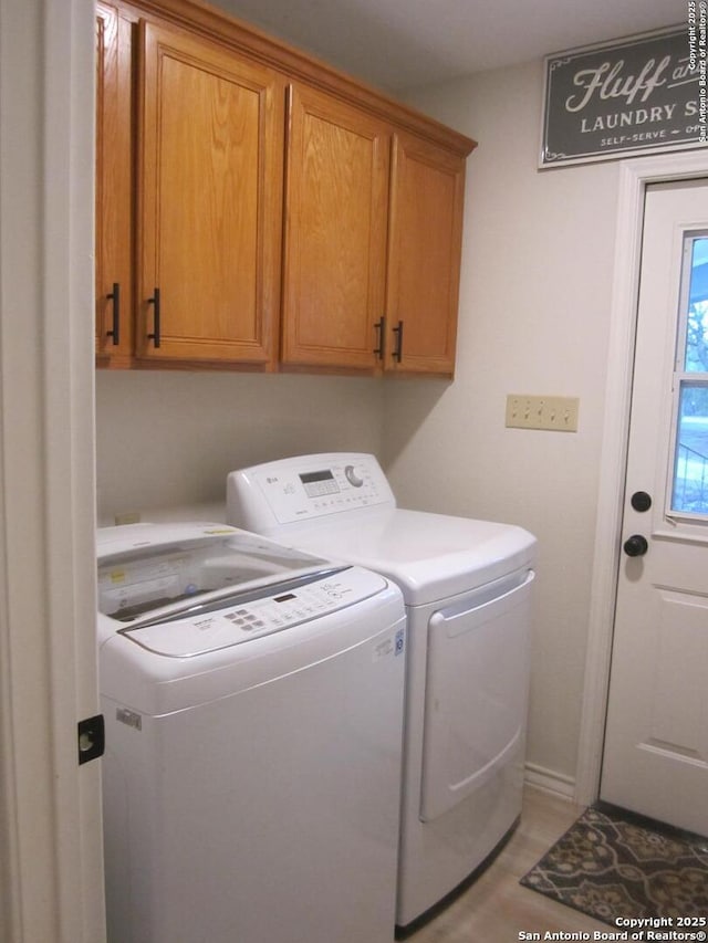 laundry area featuring cabinets and washer and dryer