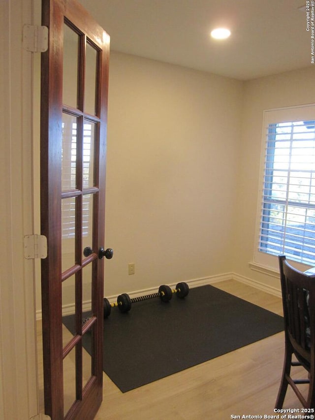 workout area with french doors and wood-type flooring