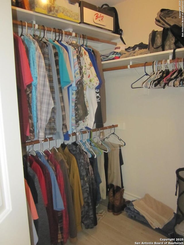 spacious closet featuring hardwood / wood-style flooring