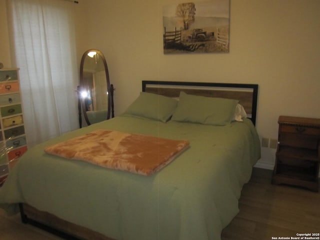 bedroom featuring dark wood-type flooring