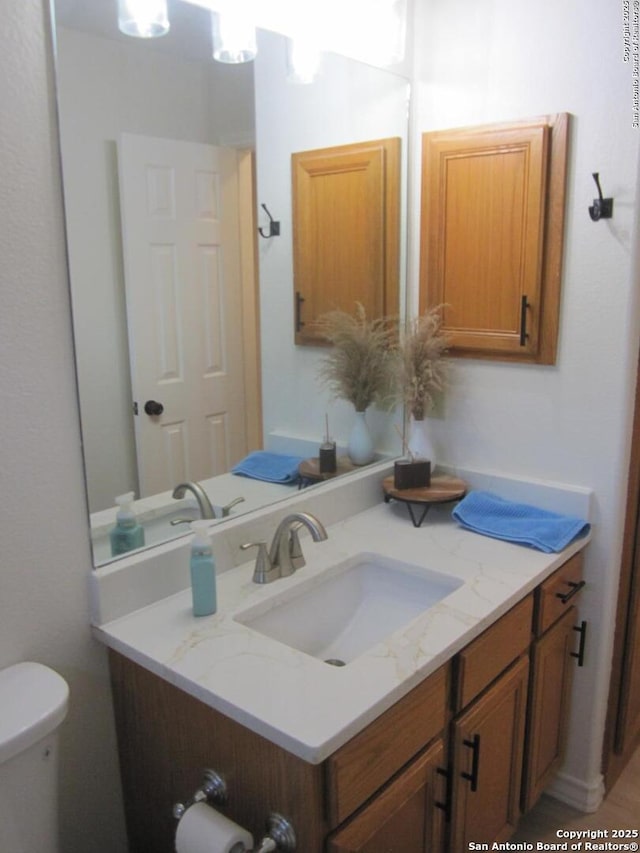 bathroom with vanity and toilet