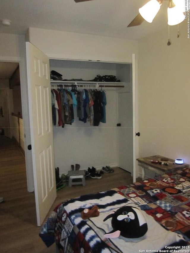 bedroom featuring ceiling fan, wood-type flooring, and a closet