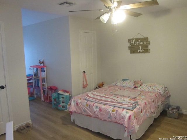 bedroom featuring hardwood / wood-style floors and ceiling fan