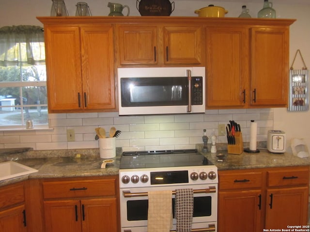 kitchen featuring backsplash and white appliances