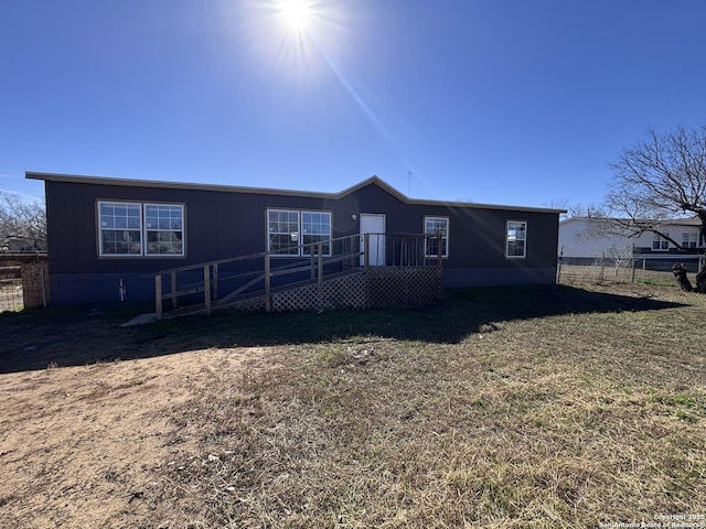 back of house with a lawn