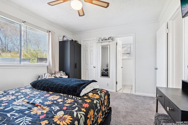 carpeted bedroom with ceiling fan, ornamental molding, and a textured ceiling