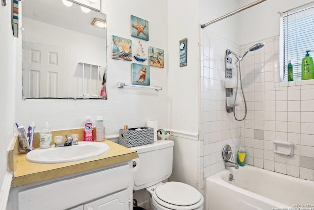 full bathroom with vanity, toilet, and tiled shower / bath combo