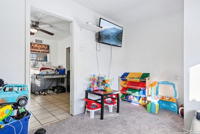 recreation room featuring ceiling fan and light colored carpet