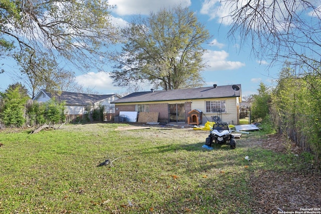 back of property featuring a lawn