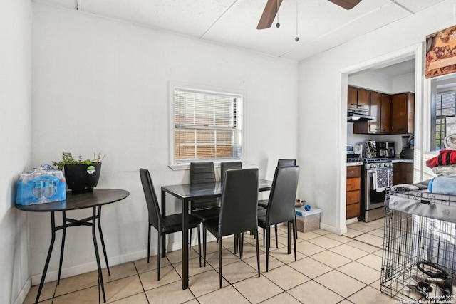 tiled dining area with ceiling fan