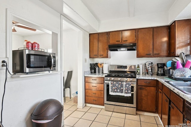 kitchen with light tile patterned flooring, ceiling fan, appliances with stainless steel finishes, and sink