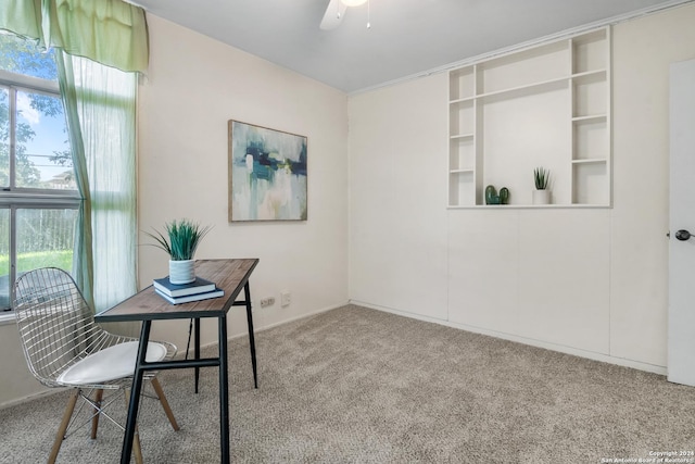 carpeted office featuring ceiling fan