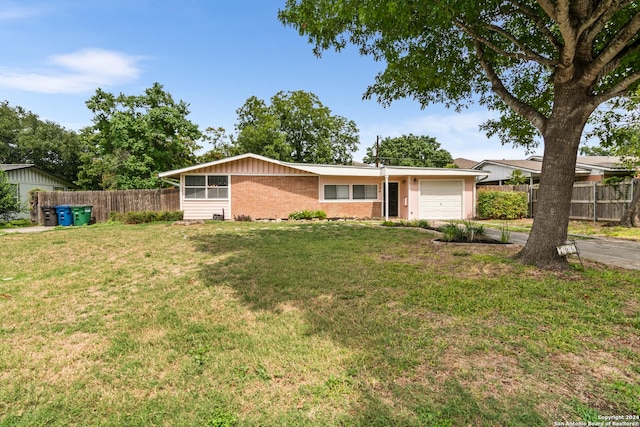 ranch-style house with a garage and a front lawn