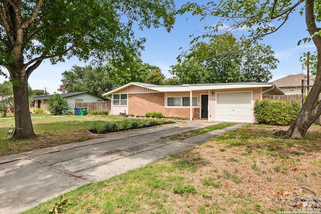 single story home featuring a garage and a front yard